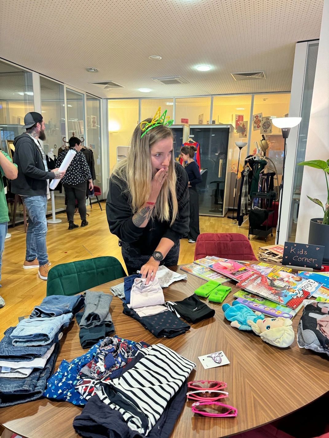 One team members looks at a table full of clothes